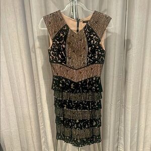 BCBGMaxAzria Black Sleeveless black lace tiered dress with tan underlay.